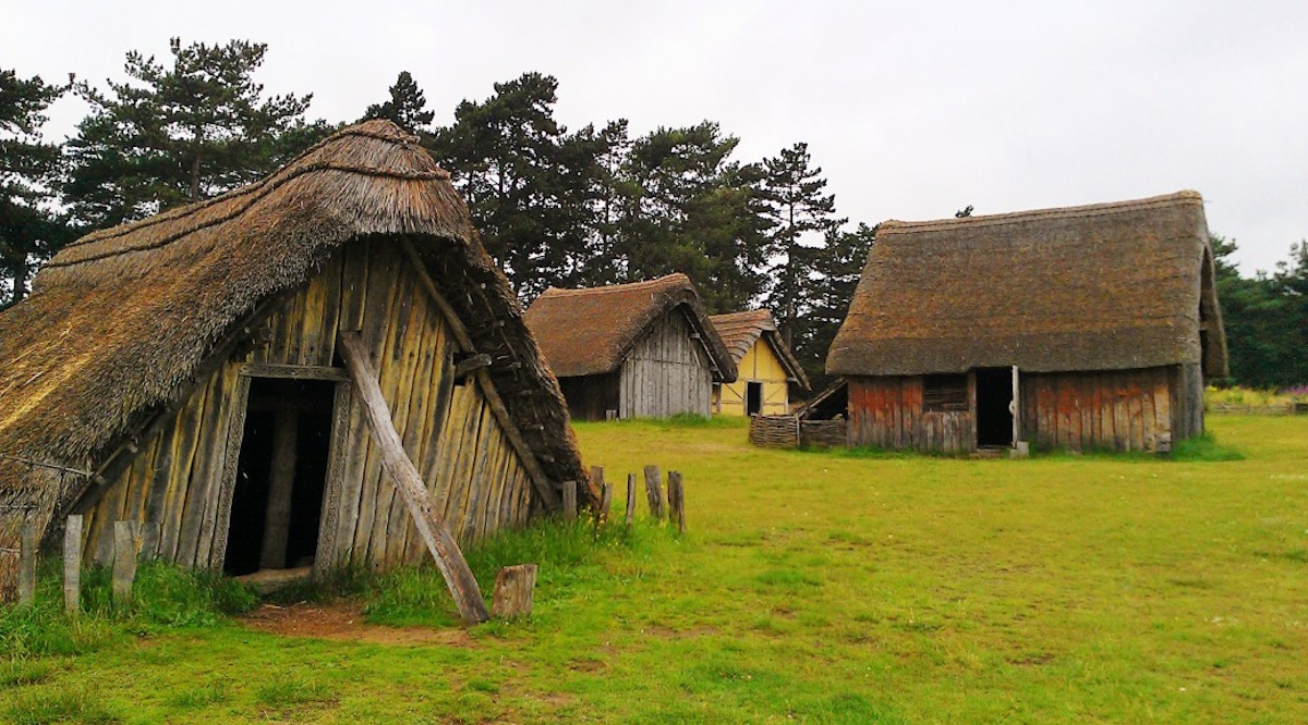 Replica of an Anglo-Saxon village, showing thatched roof houses and wooden structures