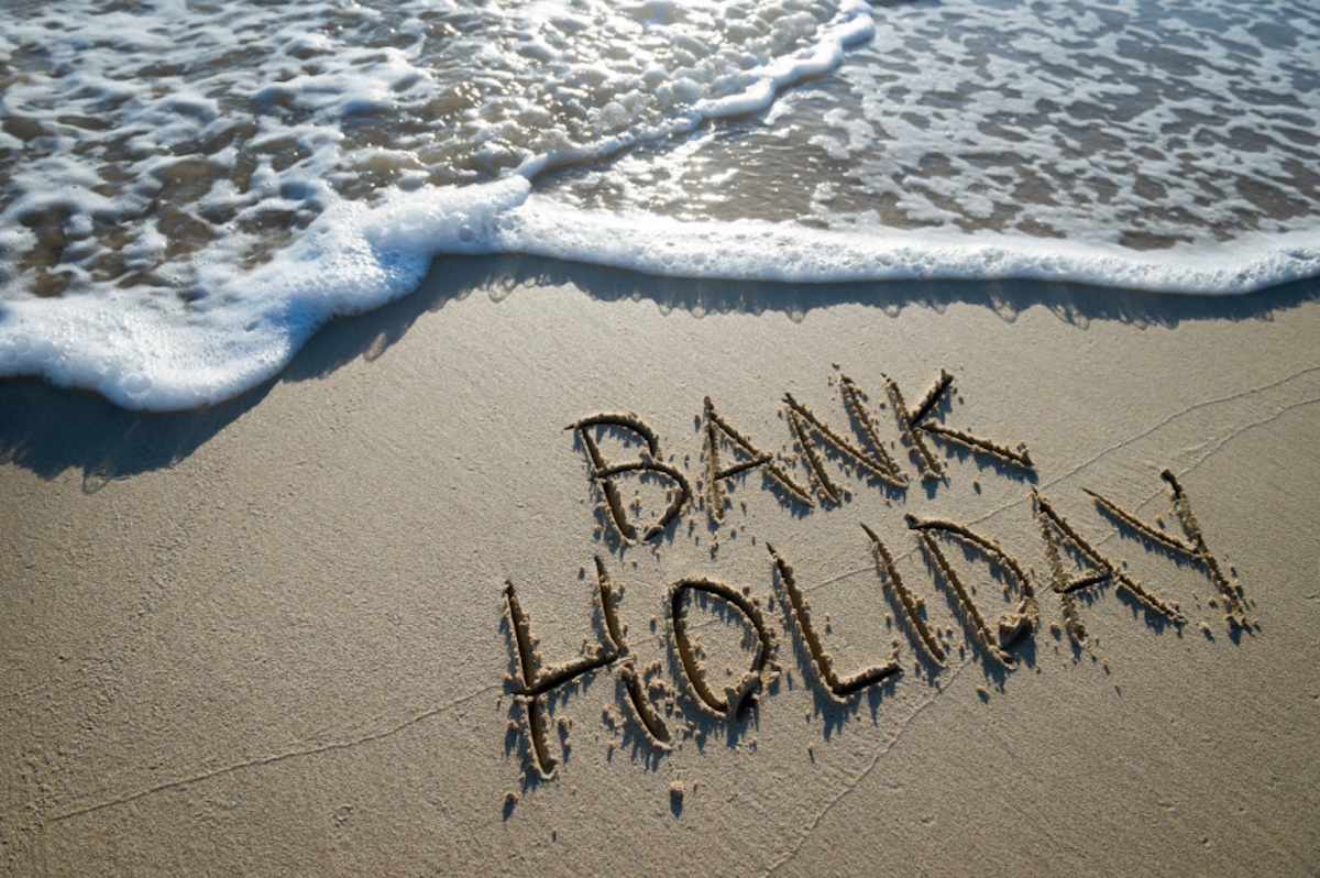 People enjoying a sunny day at the beach during a bank holiday