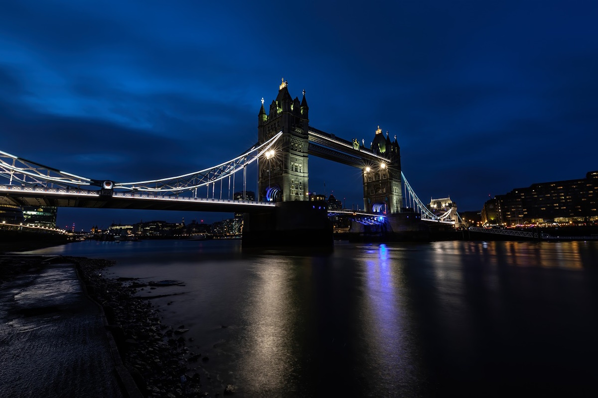 Tower Bridge illuminated at night with the River Thames