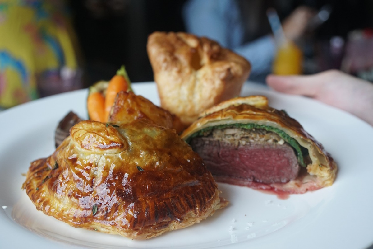 Beef Wellington sliced on a wooden board